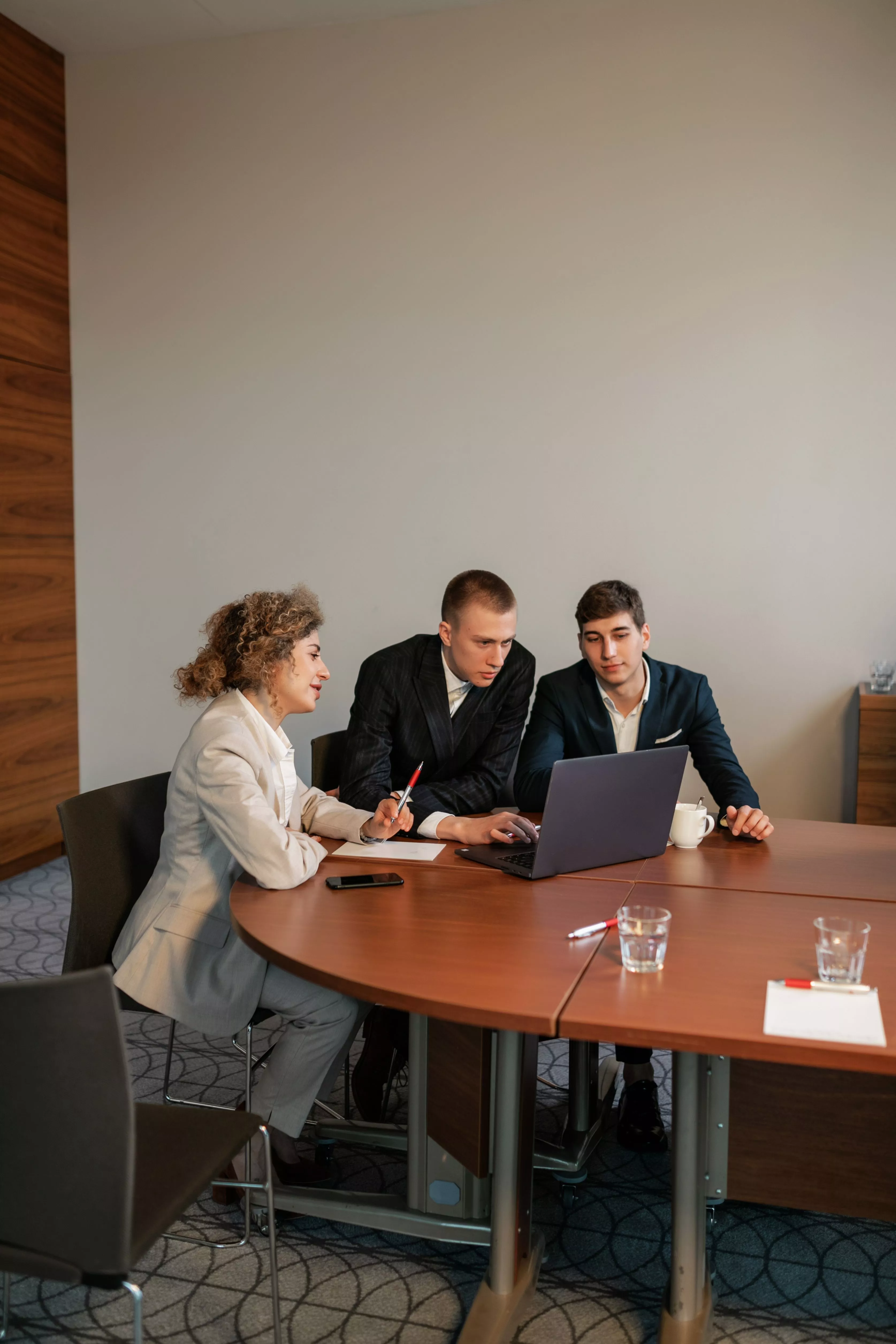 Business team collaborating around a laptop during a strategy session